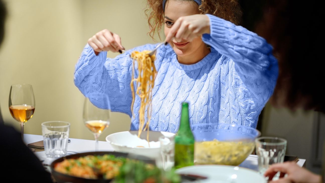 young woman serving up spaghetti